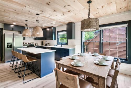 a kitchen with a wooden table and chairs at Whispering Pines - Indoor Pool, Hot Tub, Fire Pit in Sevierville