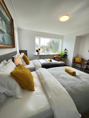 a bedroom with two beds with yellow pillows on them at Flóki by Guesthouse Reykjavík in Reykjavík