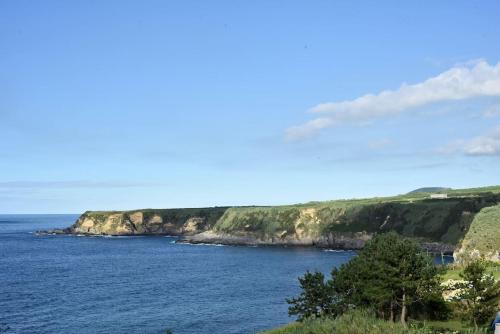 a view of a body of water with a coast at Casa das Hortênsias - Beach House in Porto Formoso