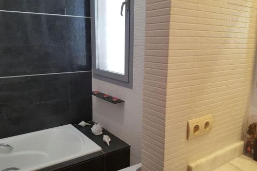 a bathroom with a tub and a toilet and a sink at Modern Zen Bali in Puerto Real