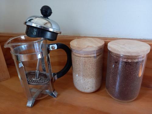 a blender and a container of food on a counter at Raglan West Accommodation Units in Raglan