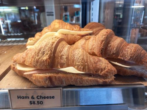 a group of sandwiches on a display case in a store at Raglan West Accommodation Units in Raglan