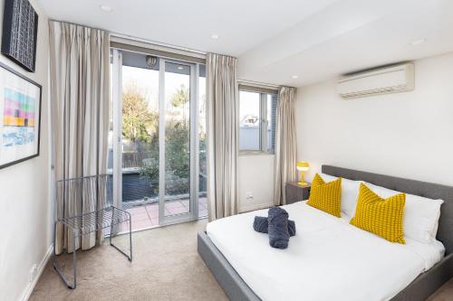 a bedroom with a bed and a large window at Surry Hills Terrace in Sydney