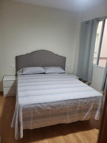 a bedroom with a bed with a white bedspread at holiday hogar altea in Altea