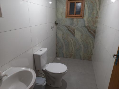 ein Bad mit einem WC und einem Waschbecken in der Unterkunft Mini lar próximo ao parque in Caparaó Velho