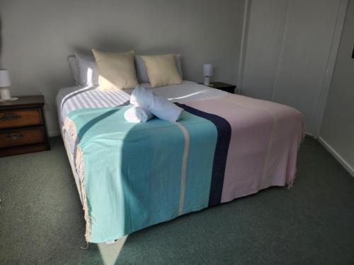 a bed with two stuffed animals sitting on top of it at Central Mountain Views Spa in Kaikoura