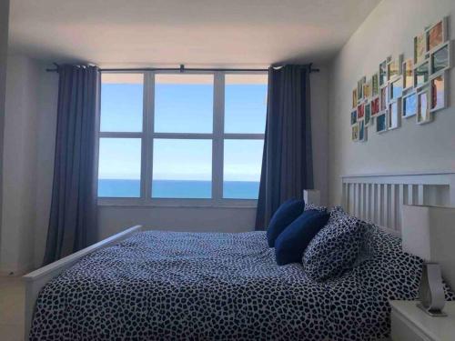 a bedroom with a bed with a large window at Pavilion - Great ocean view -Miami Beach in Miami Beach