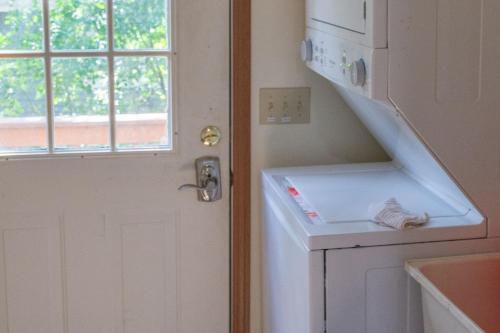 a kitchen with a white door and a window at Lakeview & Wildlife in Au Gres