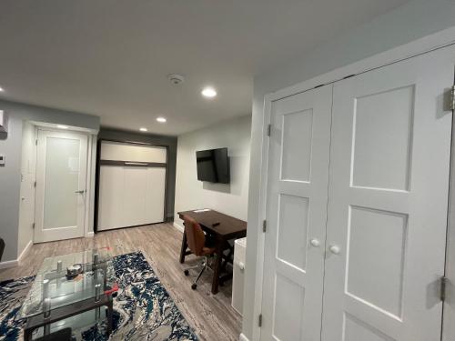 a room with a door and a desk and a table at Sonsak - Unit 5 in Charlottesville