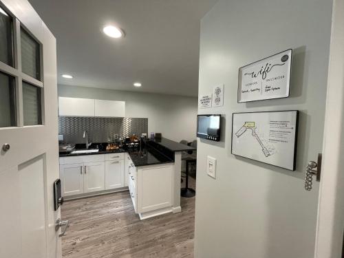 a kitchen with white cabinets and a black counter top at Sonsak - Unit 5 in Charlottesville