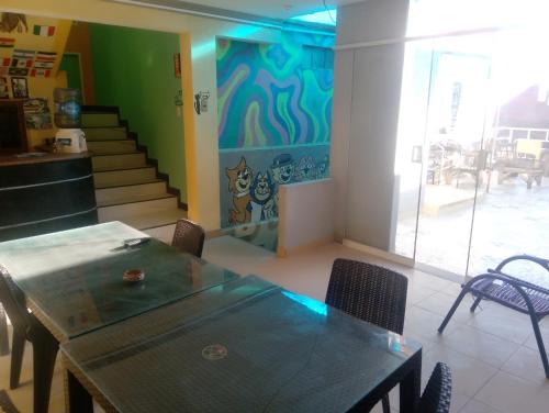 a dining room with a table and a painting on the wall at Wayky's Club and Hostal in Copacabana