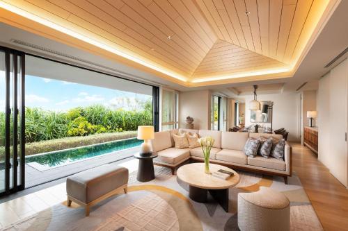 a living room with a couch and a table at Halekulani Okinawa in Onna