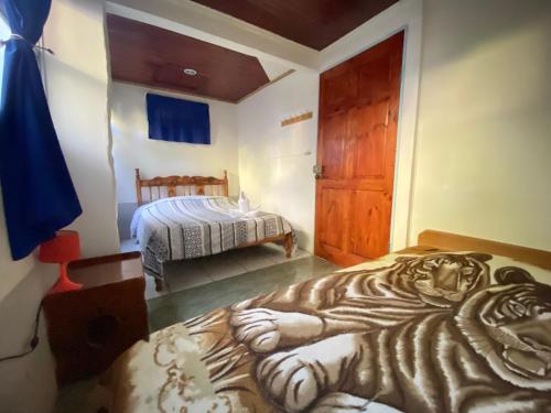 a bedroom with a tiger painted on the floor at Cabinas Nuestra Kasa in Monteverde Costa Rica