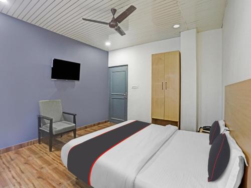 a bedroom with a large bed and a ceiling fan at Collection O Hotel Shubharambh in Kānpur