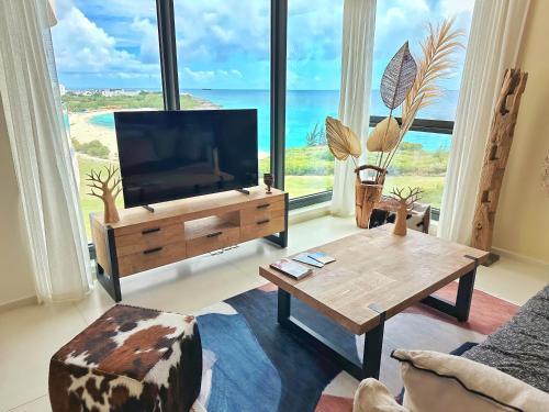 a living room with a television and a coffee table at Mullet Bay Suites - Your Luxury Stay Awaits in Cupecoy