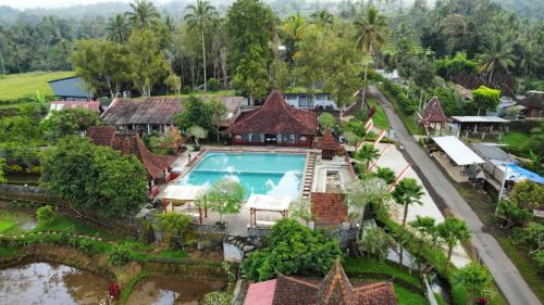 an aerial view of a house with a swimming pool at Kampoeng Joglo Ijen in Banyuwangi