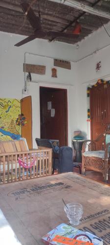 a living room with a table and chairs at HearthspaceHampi, a low-impact backpackers hostel in Hampi