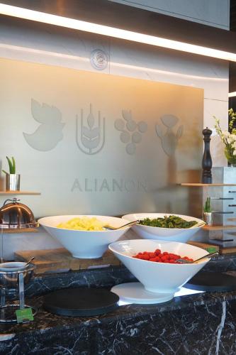 a buffet with bowls of food on a counter at Lavalse Hotel in Busan