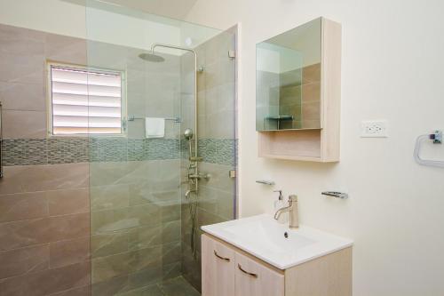 a bathroom with a sink and a shower at home with relaxing sea view in Discovery Bay