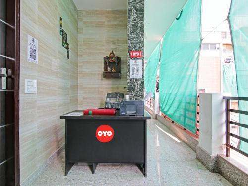 a desk with aoc sign on it in a building at OYO Flagship Moon Light Guest House in Faridabad