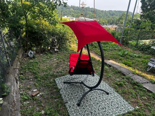 a red umbrella sitting on top of a path at 10-A Diamond in Yonkers, NY in Yonkers