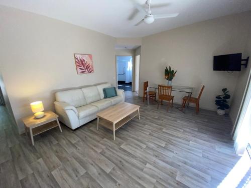 a living room with a couch and a table at Honeybee Wellness Resort in Kandanga