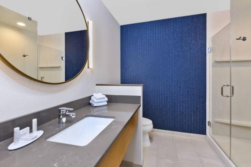 a bathroom with a sink and a mirror at Fairfield Inn & Suites by Marriott Cincinnati Airport South/Florence in Florence