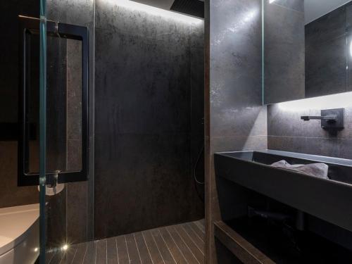 a bathroom with a shower and a sink and a tub at Chalet Haut de Gamme à Avoriaz - 11 Pers, Ski-in/Ski-out, Sauna, Terrasses Panoramiques, Service Premium - FR-1-314-114 in Morzine