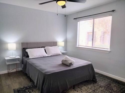 a bedroom with a bed with a ceiling fan at Mountain Foot Condo - Near Tempe and PHX Airport in Phoenix