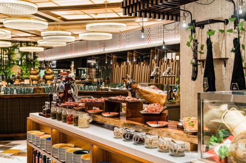 a restaurant with a buffet of food on display at Grand Lisboa Palace Macau in Macau