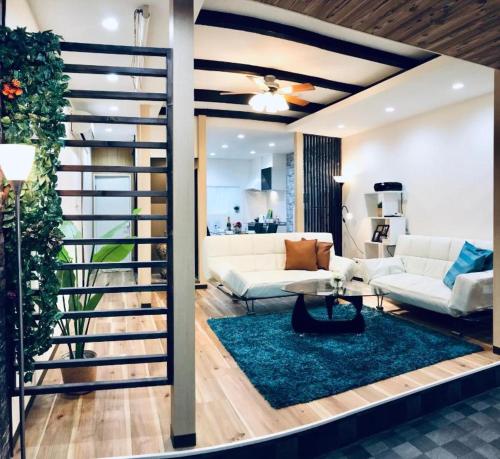 a living room with a spiral staircase in a house at Designer Room Japan Residence-Namba in Osaka