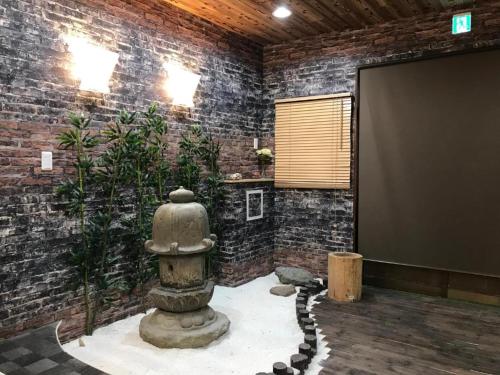 a room with a brick wall with a fire hydrant at Designer Room Japan Residence-Namba in Osaka