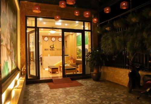 a store front with a large glass door with a living room at Đức Khôi Hotel in Cao Bằng