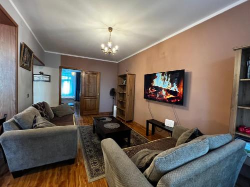 a living room with two couches and a flat screen tv at Location, locaton, location! in Ulaanbaatar