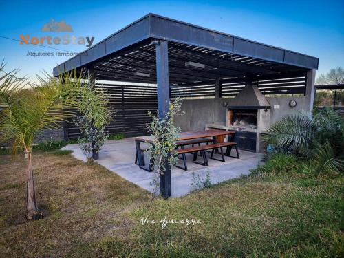 a picnic shelter with a picnic table and a grill at Cabaña - El gran escape in Salta