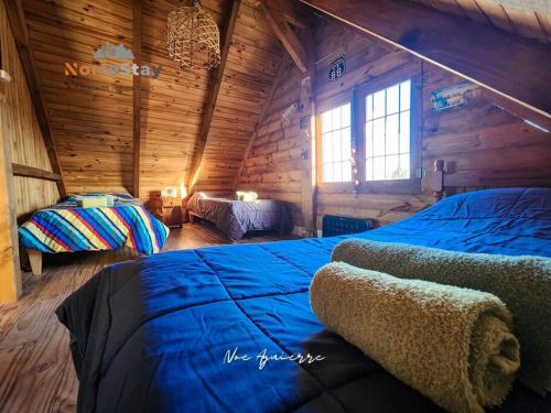 a bedroom with a bed in a wooden cabin at Cabaña - El gran escape in Salta