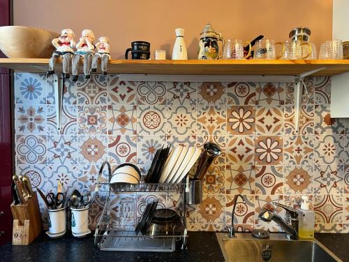 a kitchen counter with a sink and a shelf with tiles at Location, locaton, location! in Ulaanbaatar