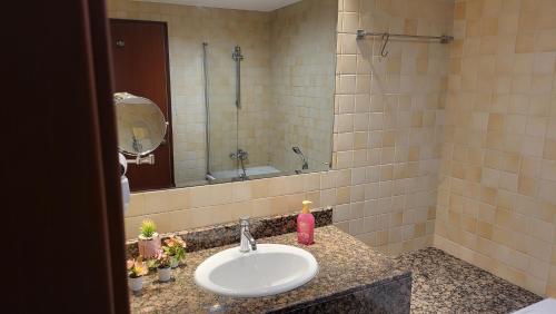 a bathroom with a sink and a mirror at Beach wave in Dubai