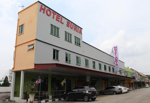 a hotel with cars parked in front of it at JQ Suria Hotel in Lahat