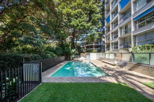 a swimming pool in the backyard of a apartment building at 'Aquarius Rising' Poolside in Rushcutters Bay in Sydney
