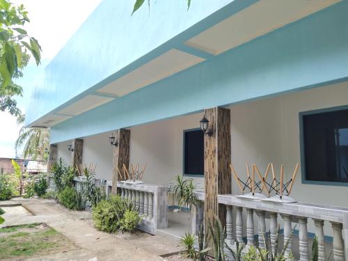 a house with a blue roof at ELEN INN - Malapascua Island Air-conditioned Room2 in Malapascua Island