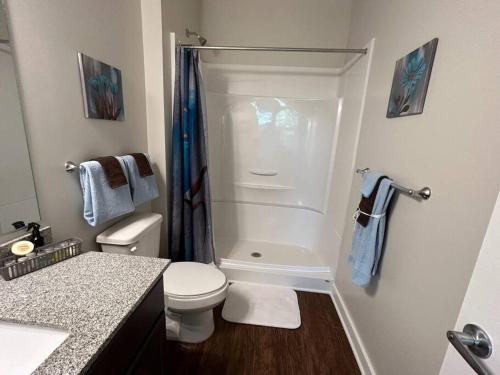 a small bathroom with a toilet and a shower at Cozy 2BR/2Bath Oasis 10 Minutes Away From Fort Lee in Brandermill