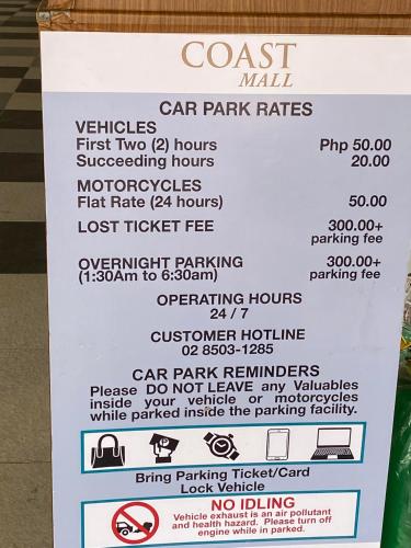 a sign for a coast mall car park rates at StayInMyCondo - 30th Condo in Pasay with Pool near Airport MOA,CCP & PICC In Pasay in Manila