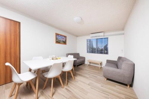 a living room with a white table and chairs at Breakers 3 - linen not included in Forster