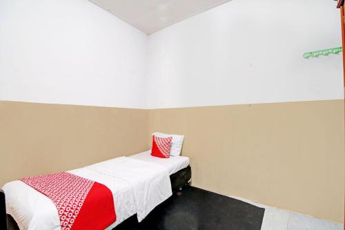 プカンバルにあるOYO 92933 Marvel House Syariahのベッドルーム1室(ベッド1台、赤と白の毛布付)