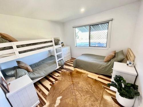 a bedroom with two bunk beds and a couch at Salty's Island Shack in Dunwich