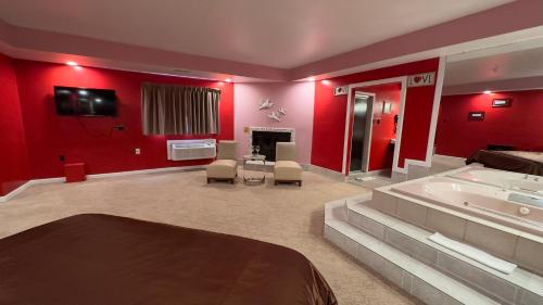 a large bathroom with a tub and red walls at Inn of the Dove - Romantic Luxury Suites with Jacuzzi & Seasonal Fireplace at Harrisburg-Hershey-Philadelphia, PA in Harrisburg