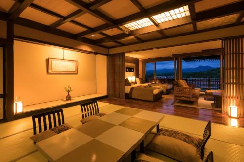 a dining room with a table and a living room at Yunokuni Tensyo in Kaga