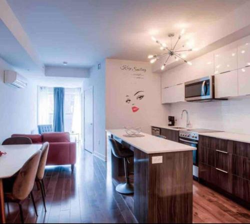 a kitchen with a counter and a living room at 2 bedroom Condo in the heart of the city Montreal in Montréal