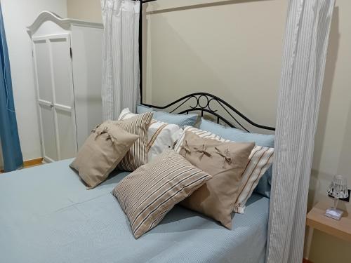 a bedroom with a bed with pillows on it at Casa vacanza Argo. Bovo marina/torre salsa in Montallegro